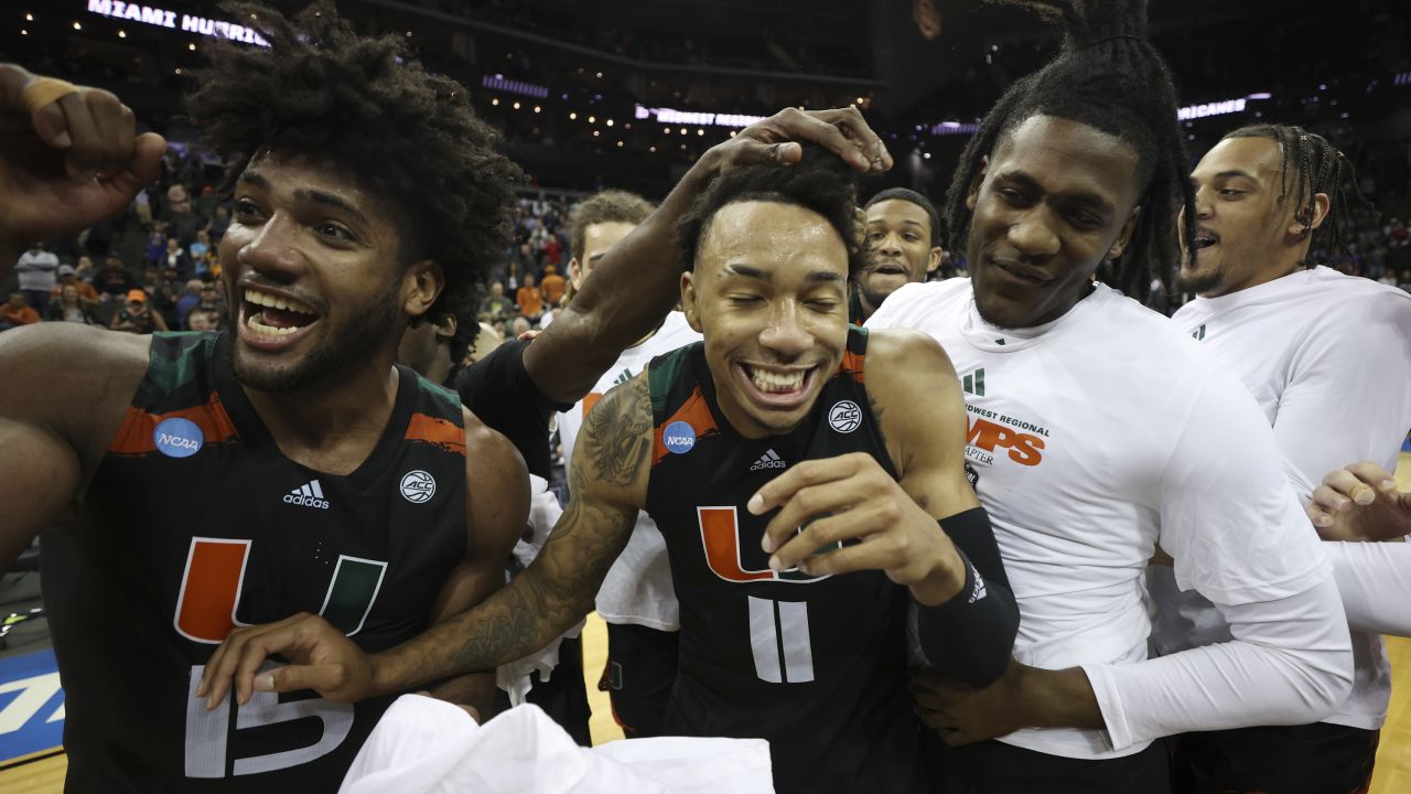 Norchad Omier and Jordan Miller celebrate with teammates after defeating the Texas Longhorns in the Elite Eight.