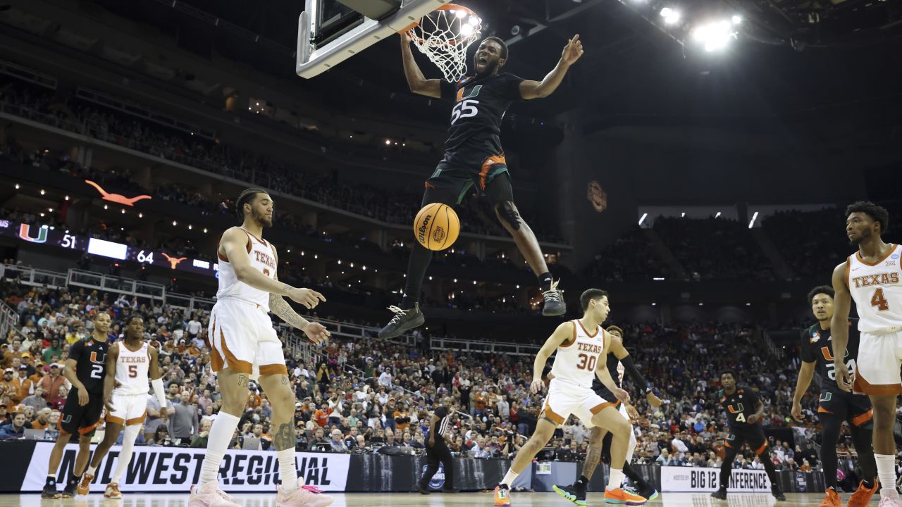 Wooga Poplar of the Miami Hurricanes celebrates as he dunks the ball during the second half against the Texas Longhorns in the Elite Eight. 