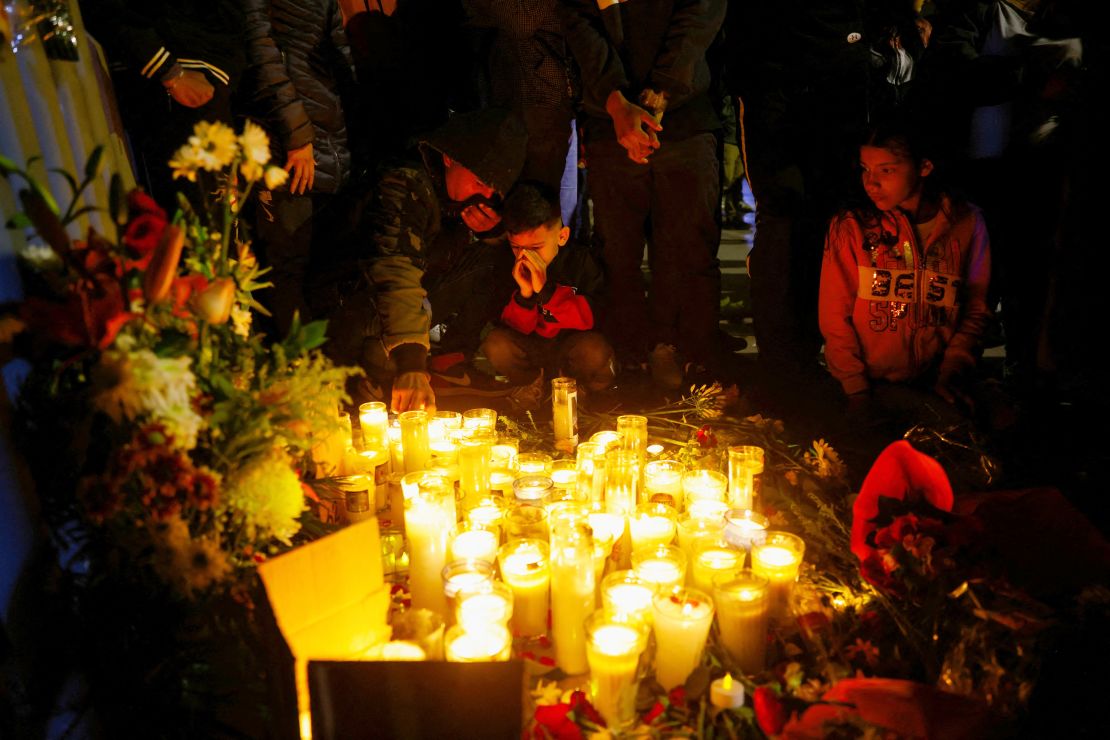 Migrants hold a candle vigil outside the office of the National Institute of Migration (INM) in memory of the victims of the fire.