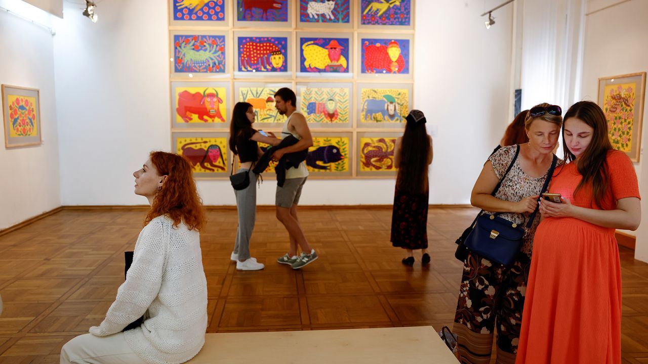 Lviv museum visitors view works by Maria Prymachenko, who says going to see art is a 