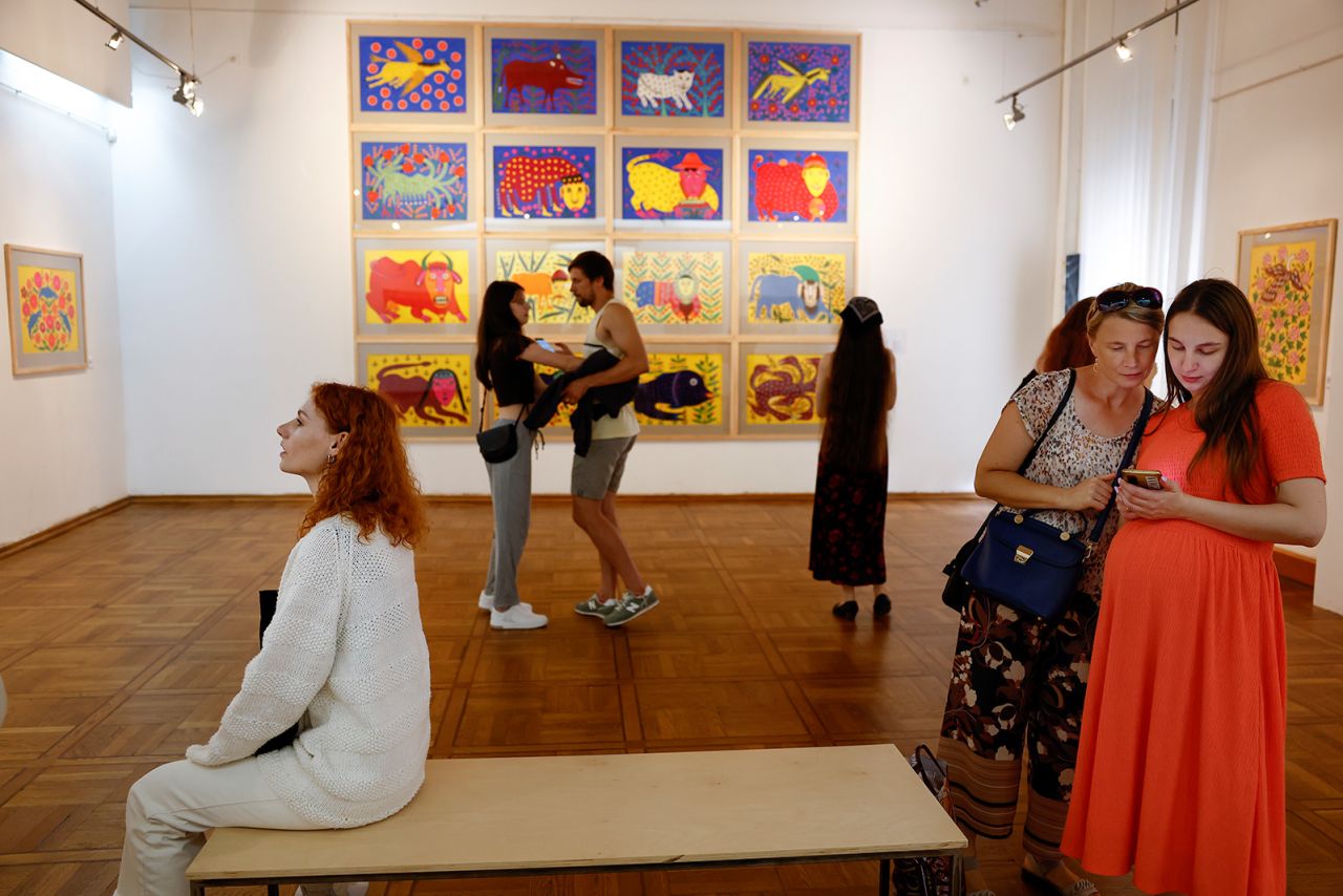 Lviv museum visitors view works by Maria Prymachenko, who says going to see art is a "kind of therapy."