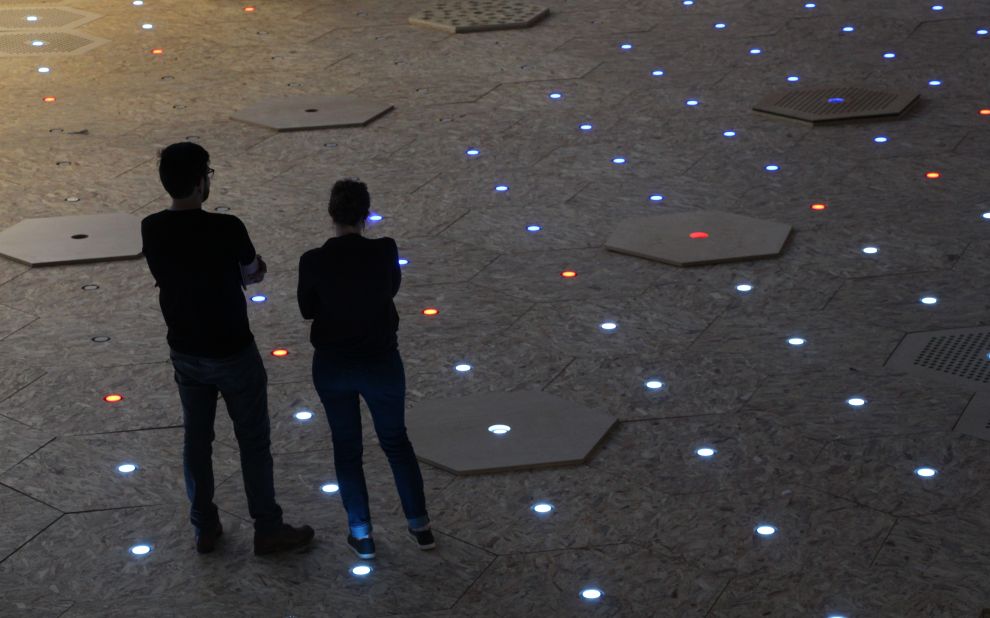 It experiments with different patterns using hexagonal pavers and lights.