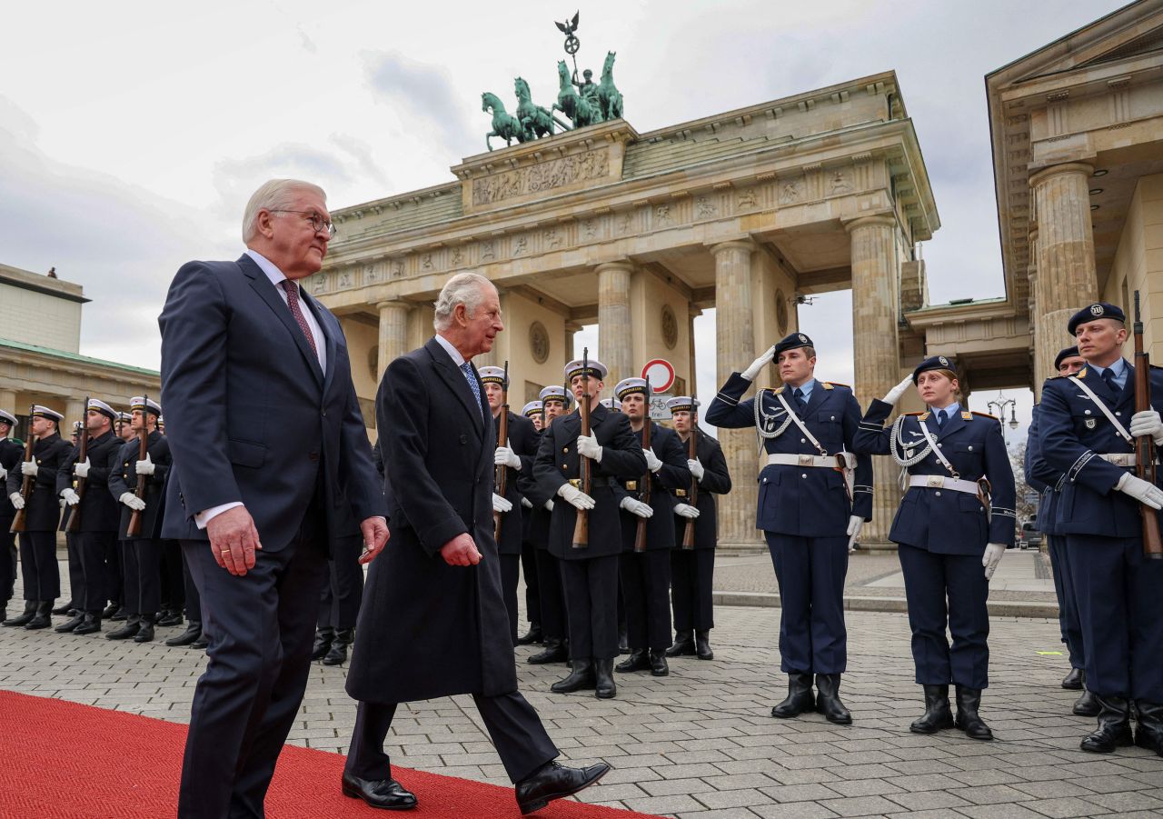 The King and Steinmeier inspect a guard of honor during a ceremonial welcome at Berlin's Brandenburg Gate.