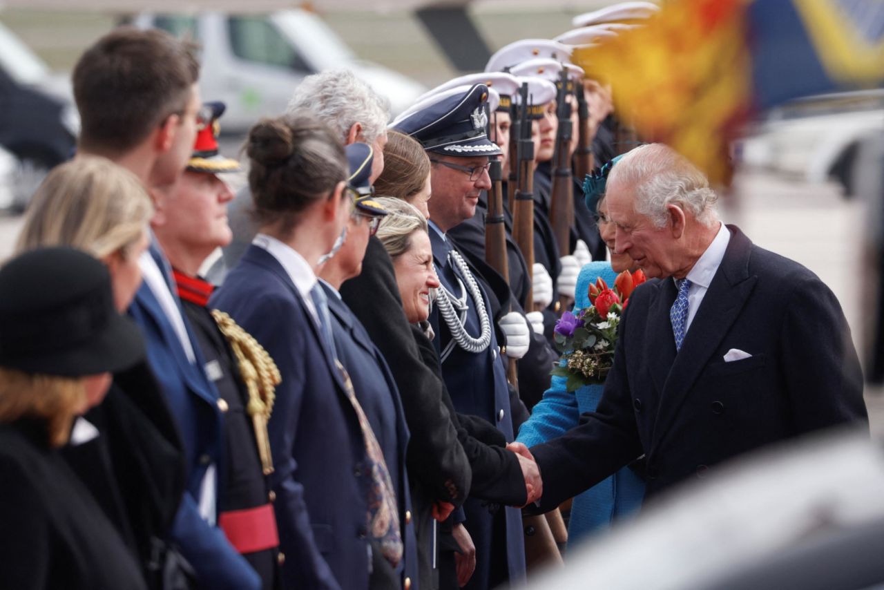 The King shakes hands after arriving at Berlin Brandenburg Airport.