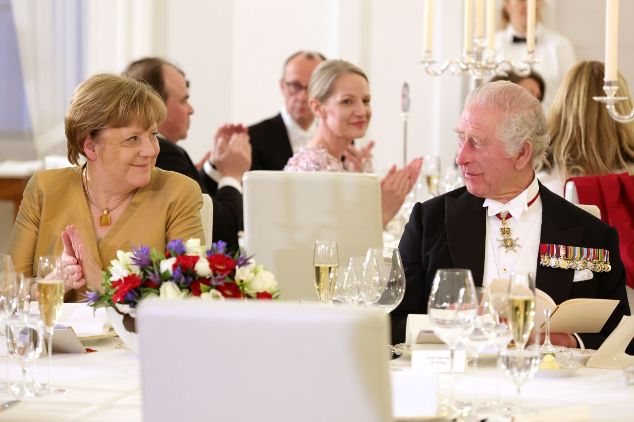 Former German Chancellor Angela Merkel, left, and the King attend the state banquet on Wednesday.