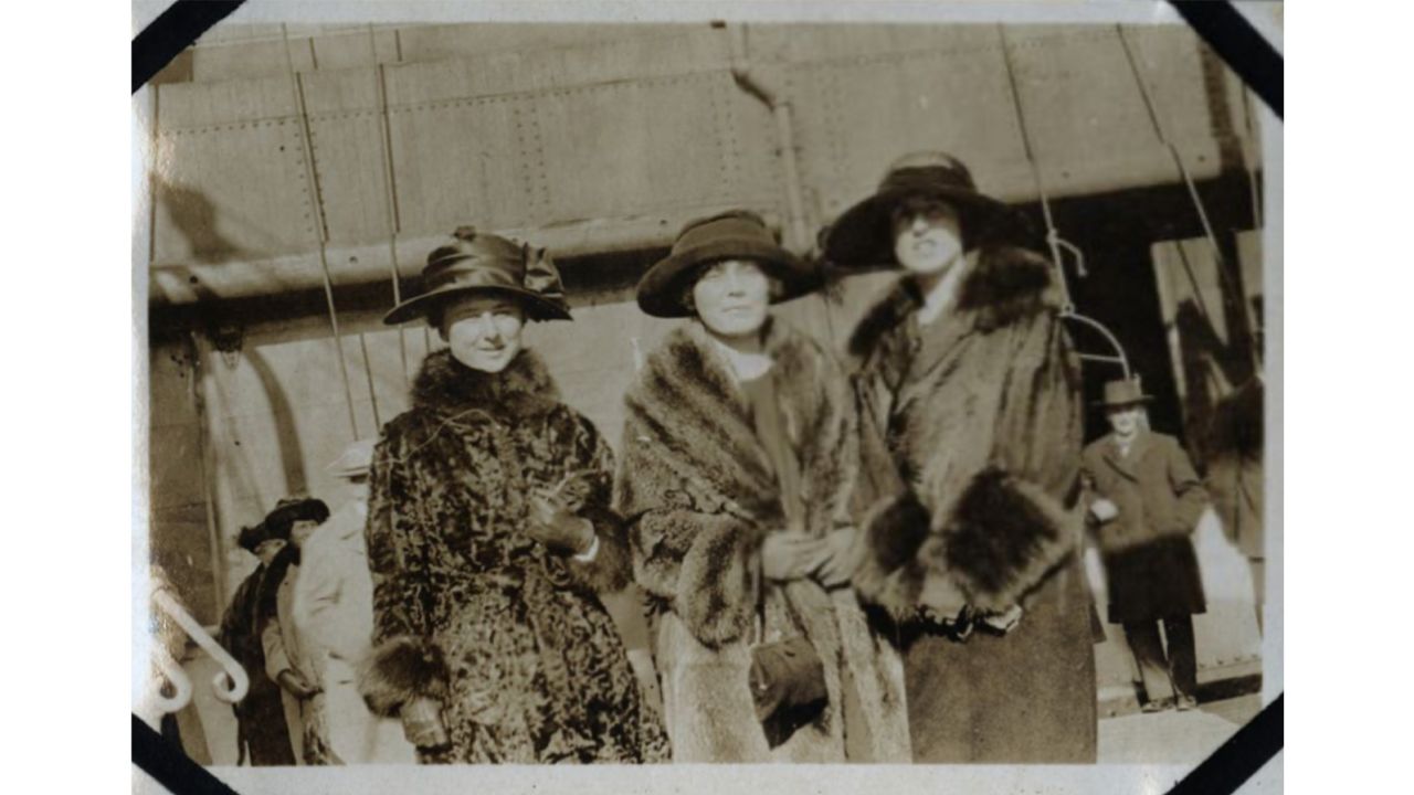 This photograph from Eleanor Phelps' Laconia scrapbook depicts travelers on board as the ship departed New York. Eleanor's sister Claudia Phelps is in the center.