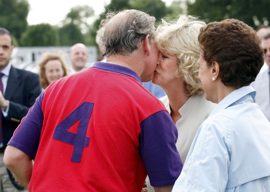 Charles kisses Camilla after a Burberry Cup polo match in Cirencester, England, in June 2005.