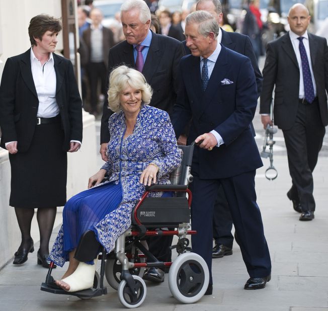 Charles pushes Camilla in a wheelchair as they attend the premiere of "Aida" at the Royal Opera House in London in April 2010. She had suffered a broken leg weeks prior. 