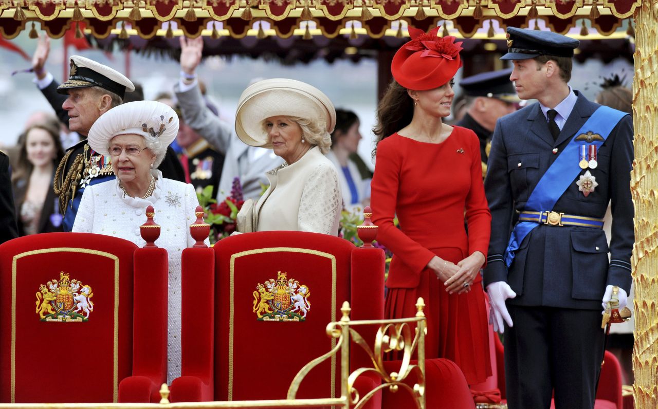 Camilla stands next to Queen Elizabeth II during a Diamond Jubilee pageant on the River Thames in June 2012. At right are Prince William and his wife, Catherine.