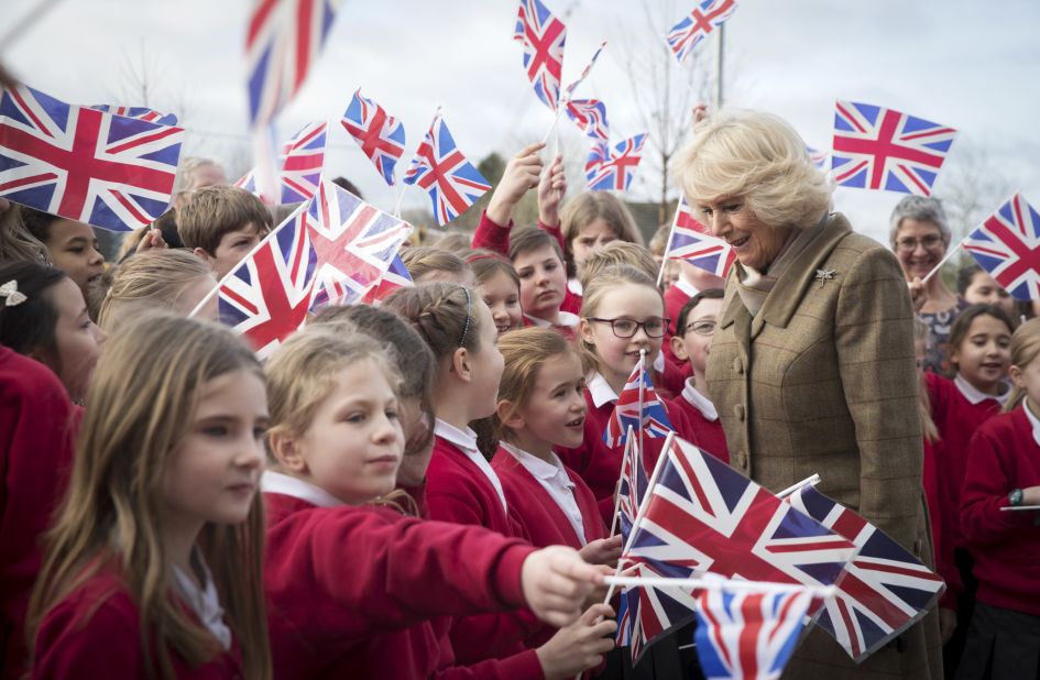 Camilla is greeted by flag-waving schoolchildren in Marlborough, England, in January 2018.