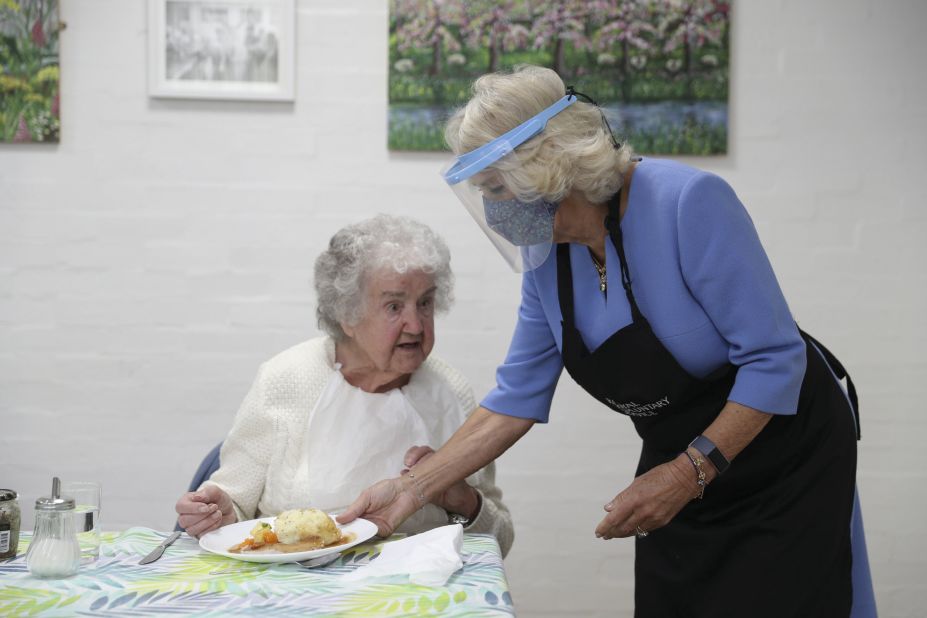 Camilla serves lunch at the Royal Voluntary Service Club in Rickmansworth, England, in October 2020. She was wearing a face shield because of the Covid-19 pandemic.