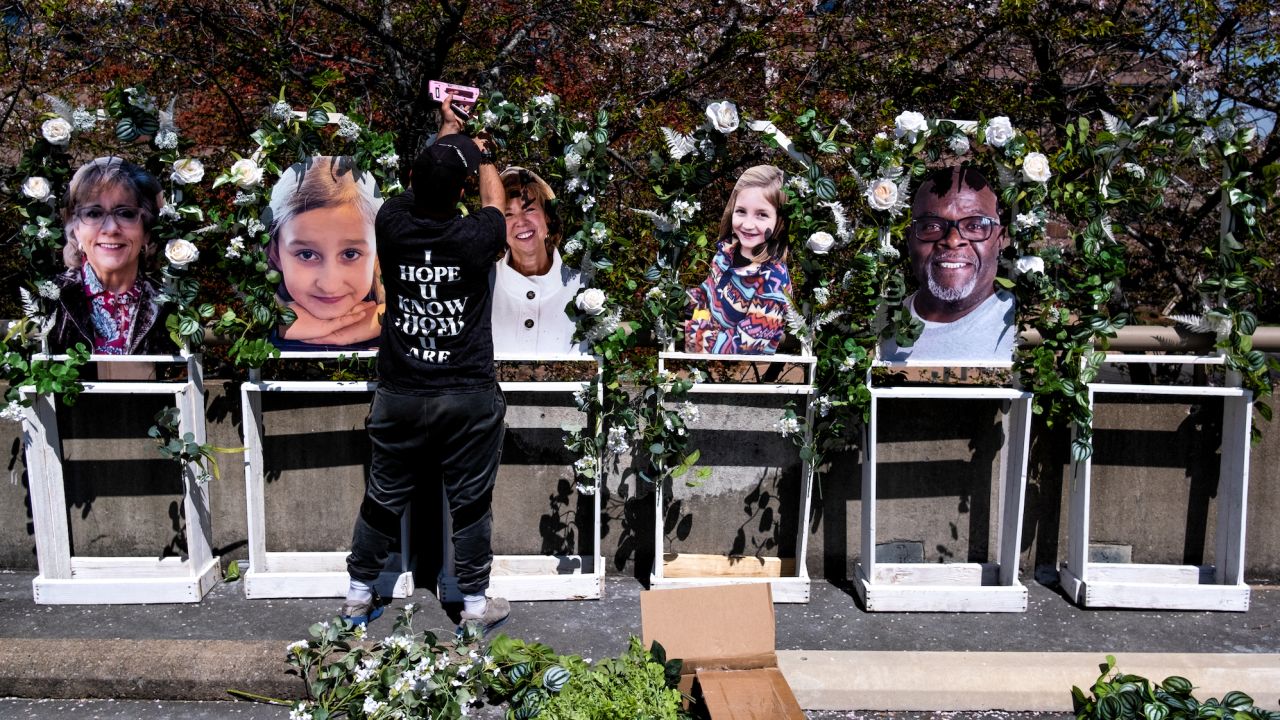 Pictures of the victims killed in the mass shooting at The Covenant School are fixed to a memorial by Noah Reich from the non-profit Classroom of Compassion near the school on Wednesday.