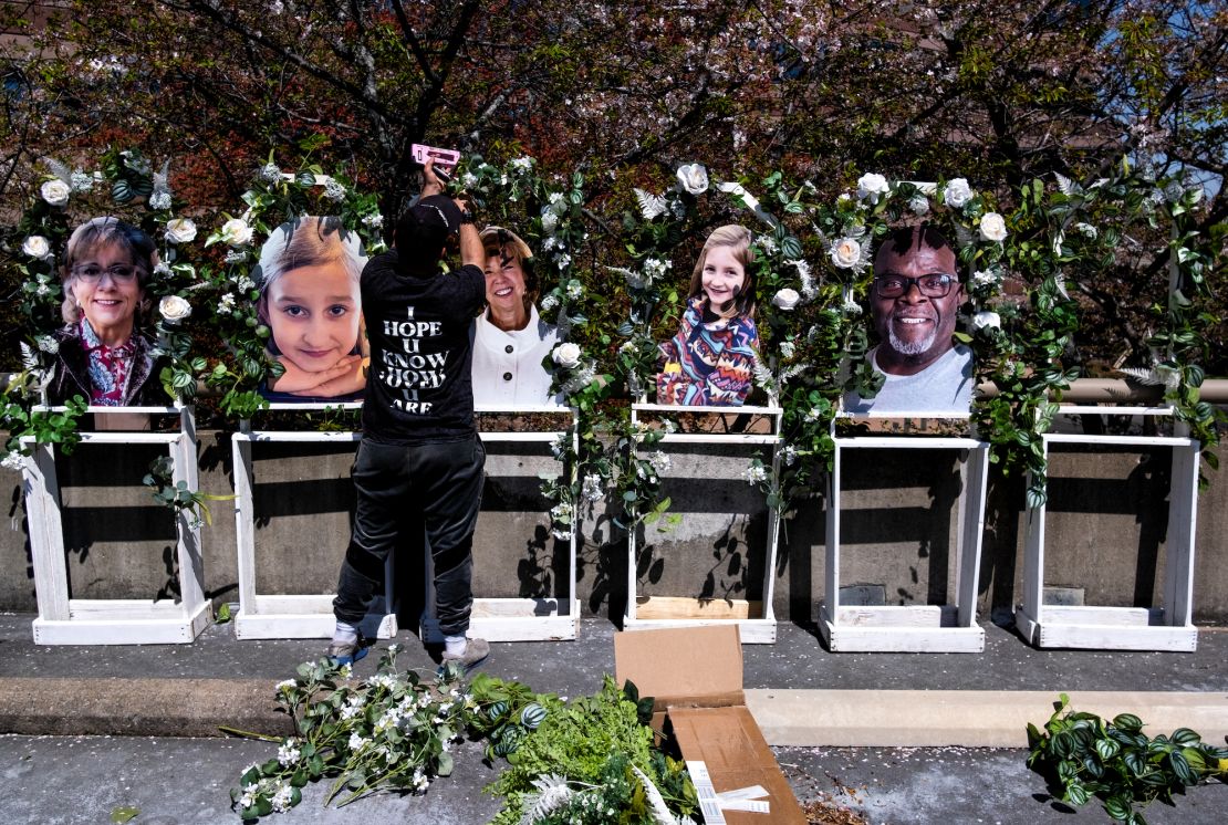 Pictures of the victims killed in the mass shooting  at The Covenant School are fixed to a memorial by Noah Reich from the non-profit Classroom of Compassion near the school on Wednesday.