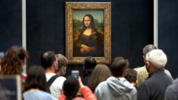 Visitors view the painting of "Mona Lisa" by Italian artist Leonardo Da Vinci at the Louvre museum on July 6, 2020, in Paris, France. 