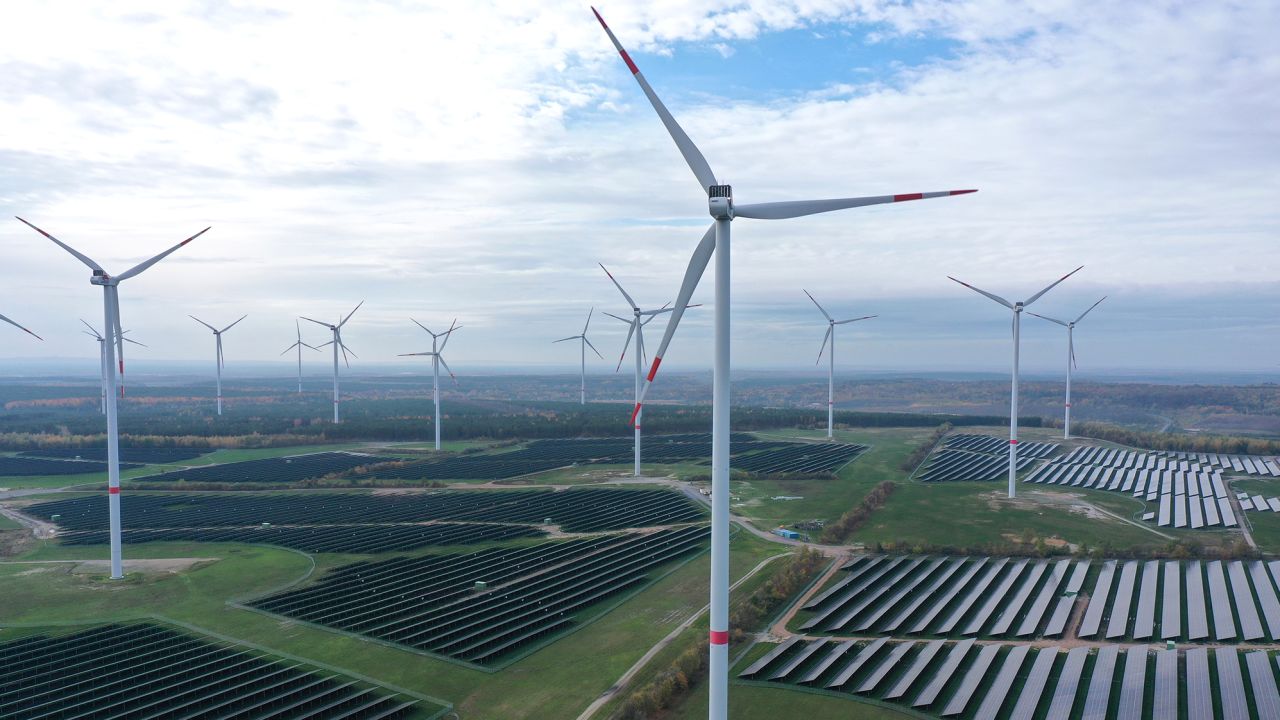 Wind turbines spin over a solar park near Klettwitz, Germany. 