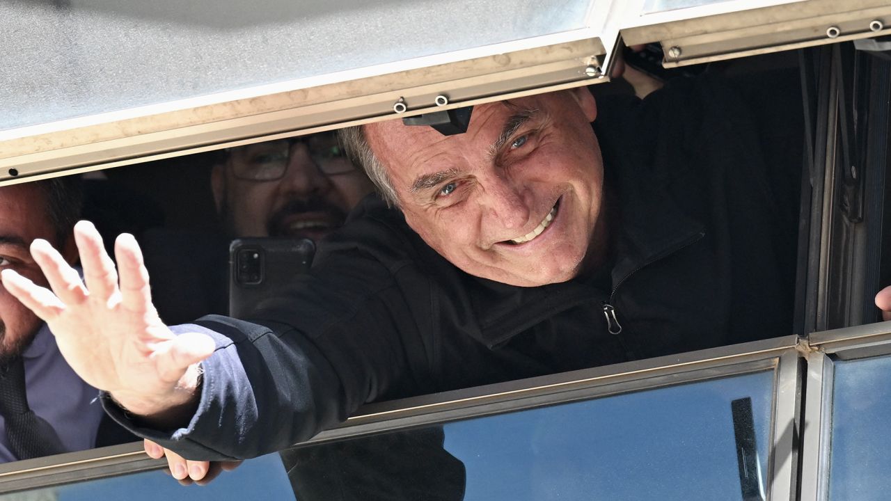 Bolsonaro waves from the Liberal Party headquarters in Brasilia on Thursday.