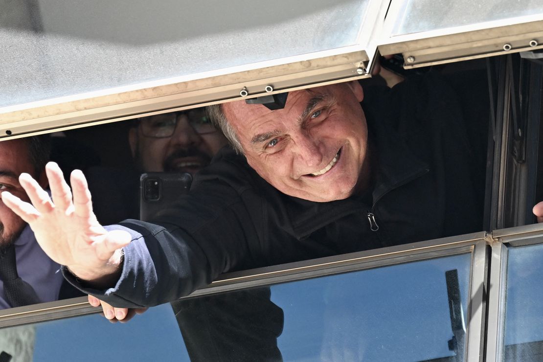 Bolsonaro waves from the Liberal Party headquarters in Brasilia on Thursday.