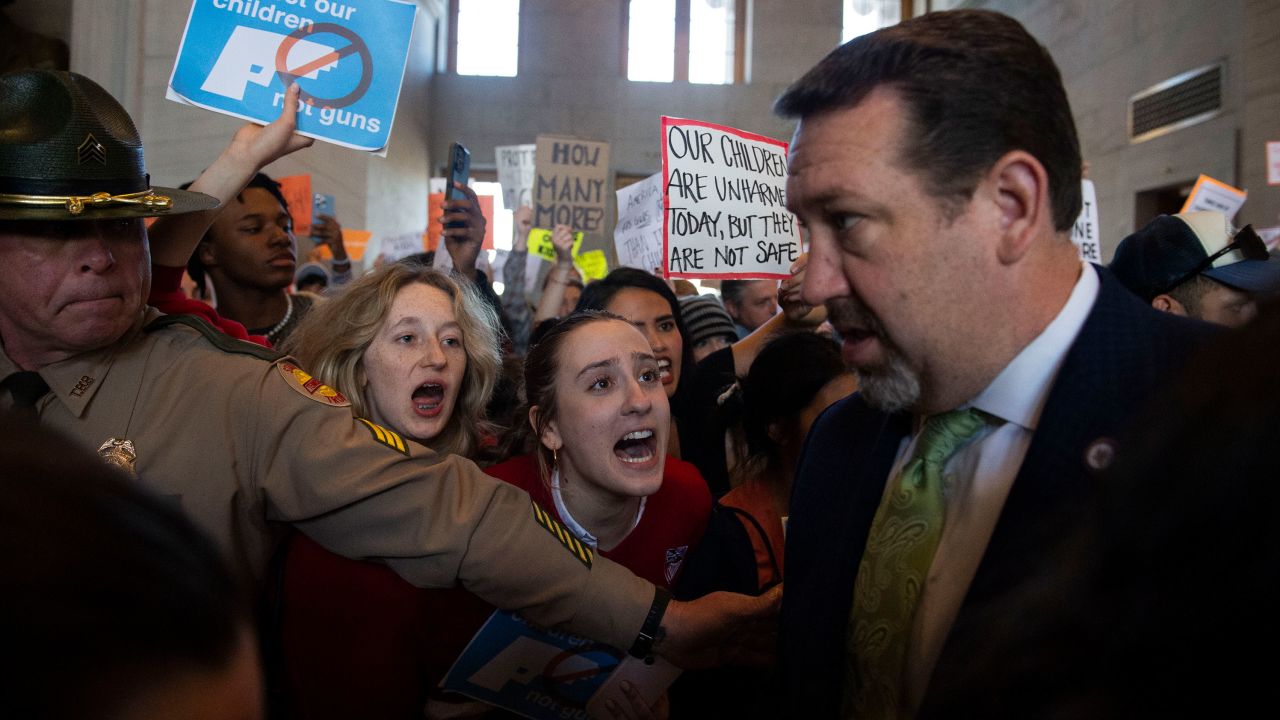 Addie Brue, 16, and Madeline Lederman, 17, shout "do something," with other protesters as Rep. Jeremy Faison, Chairman of the House Republican Caucus, walks towards the House chamber doors at the State Capitol Building in Nashville, on Thursday.