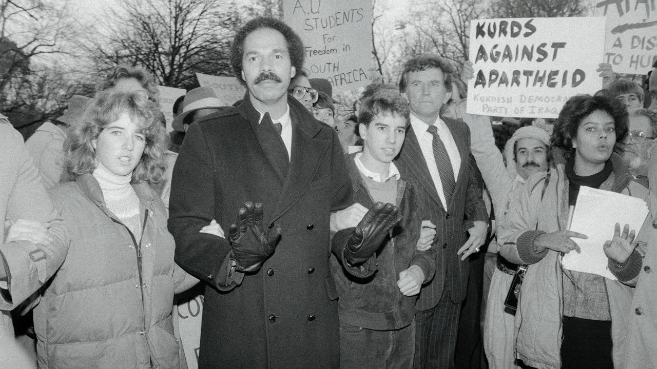 Randall Robinson, center, during a demonstration against South African government's apartheid policies at the South African Embassy in Washington, DC. 