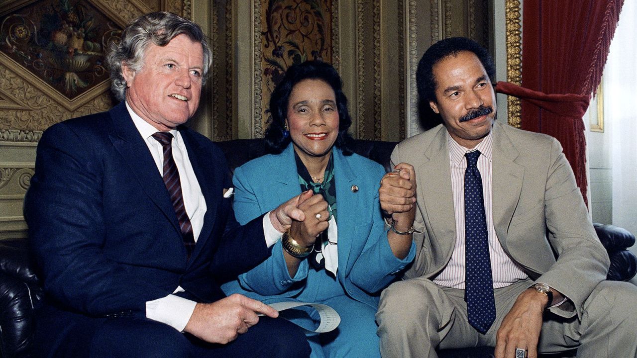 Former Sen. Edward Kennedy, left, Coretta Scott King, center, and Randall Robinson, right, in Washington after a Congress vote to override a veto new sanctions against South Africa in 1986.