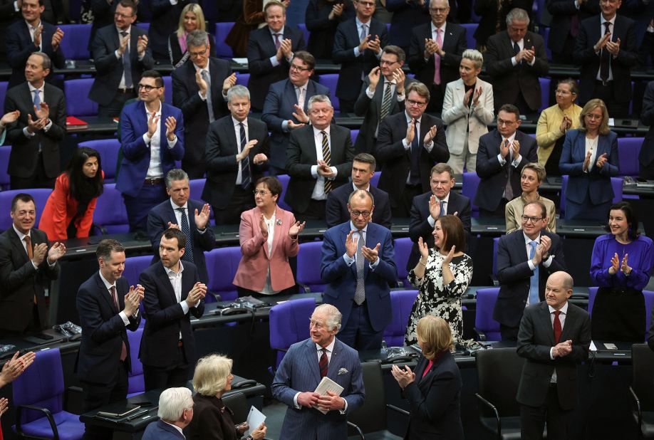 The King, front center, receives applause after delivering a speech at the Bundestag, Germany's parliament, on Thursday. He said he was proud to be in Berlin to "renew the special bond of friendship between our two countries," and he said the friendship between the two nations "meant so much to my beloved mother," who spoke often of her visits to the country.