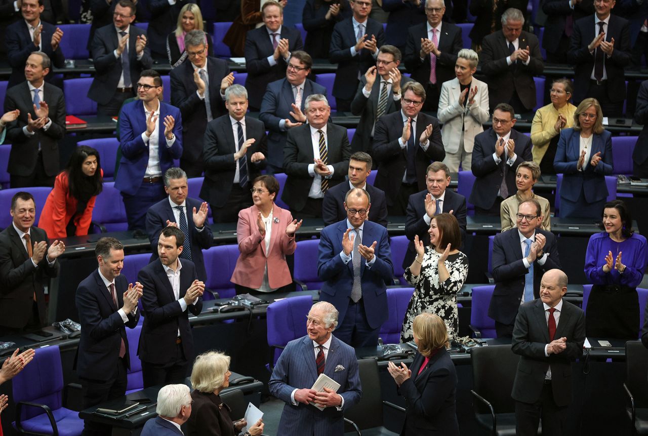 The King, front center, receives applause after delivering a speech at the Bundestag, Germany's parliament, on Thursday. He said he was proud to be in Berlin to "renew the special bond of friendship between our two countries," and he said the friendship between the two nations "meant so much to my beloved mother," who spoke often of her visits to the country.