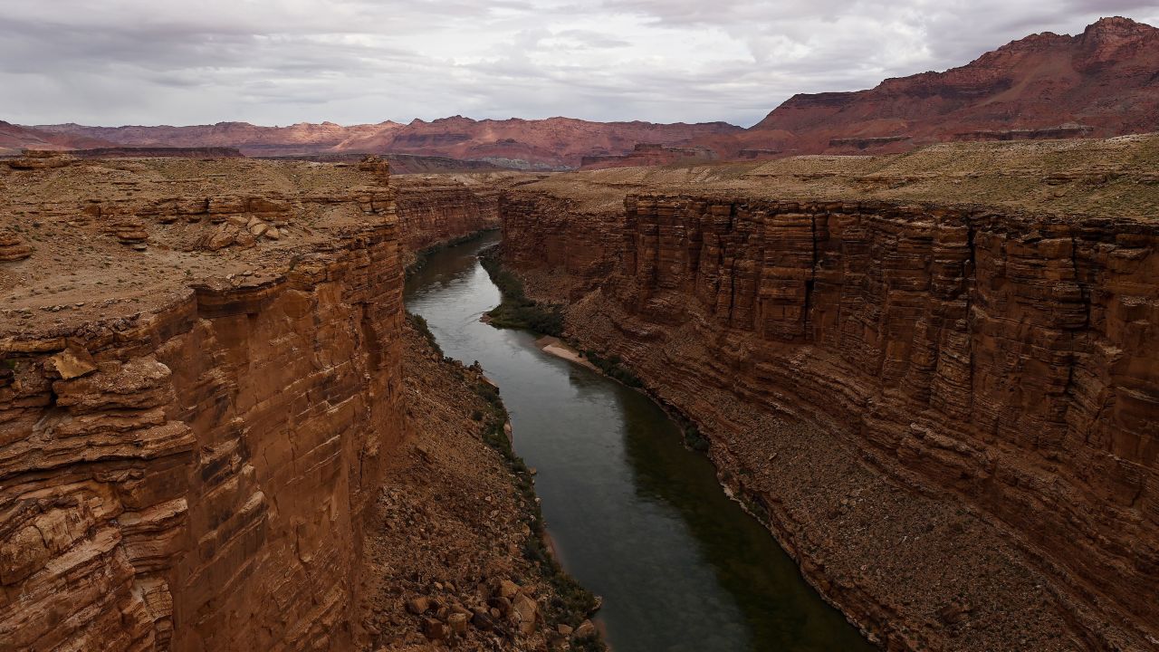 The Colorado River flows between canyon walls in Marble Canyon, Arizona.