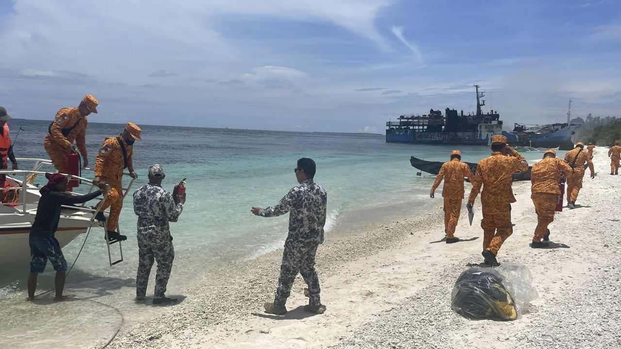 Members of the Philippine Coast Guard check the remains of the MV Lady Mary Joy on Thursday, after the ferry caught fire and killed at least 29 people. 