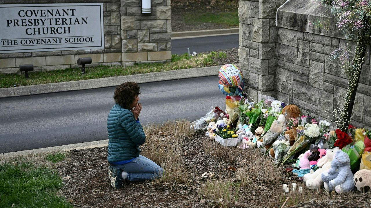 Robin Wolfenden prays at a makeshift memorial Tuesday for the victims outside The Covenant School building in Nashville.