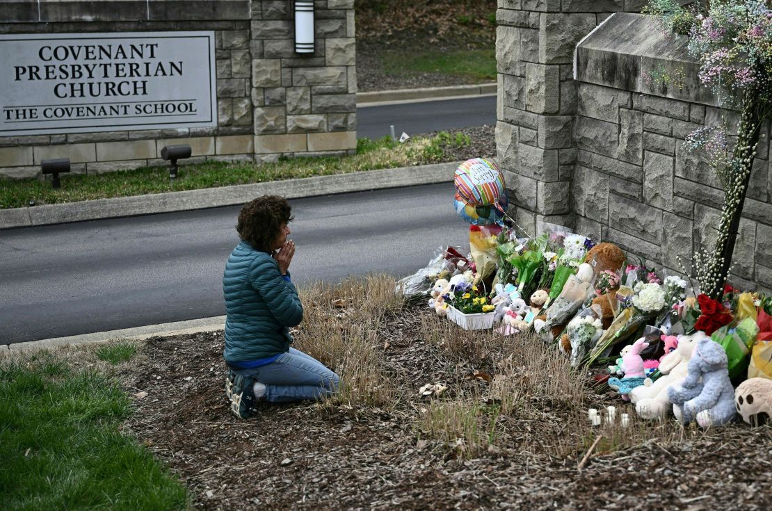 Robin Wolfenden prays at a makeshift memorial Tuesday for the victims outside The Covenant School building in Nashville.