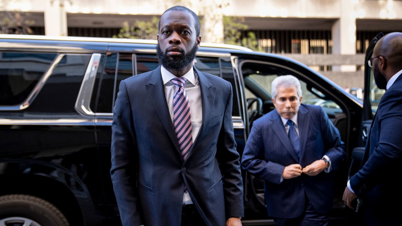 Prakazrel "Pras" Michel, center, a former member of the 1990s hip-hop group the Fugees, arrives at federal court for his trial in an alleged campaign finance conspiracy, March 30, 2023, in Washington. 