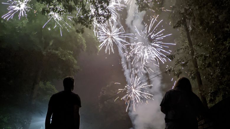 People watch fireworks during a Fourth of July celebration, in this photo taken using the Google Pixel 5 Night Sight setting.