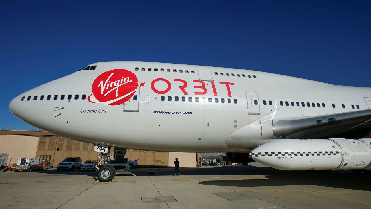 Richard Branson's Virgin Orbit, with a rocket underneath the wing of a modified Boeing 747 jetliner, prepares for a key drop test of its high-altitude launch system for satellites in July 2019.