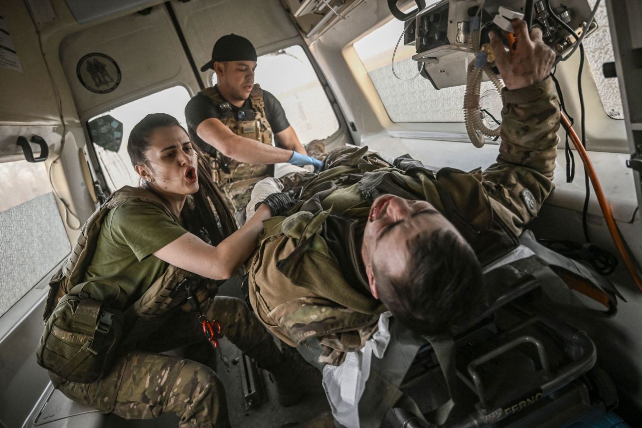 Ukrainian military paramedics tend to a wounded serviceman as they move him away from the front lines near Bakhmut, Ukraine, on Thursday, March 23. He was hit by shrapnel in the arm and leg, but his injuries were not life-threatening, according to Agence France-Presse.