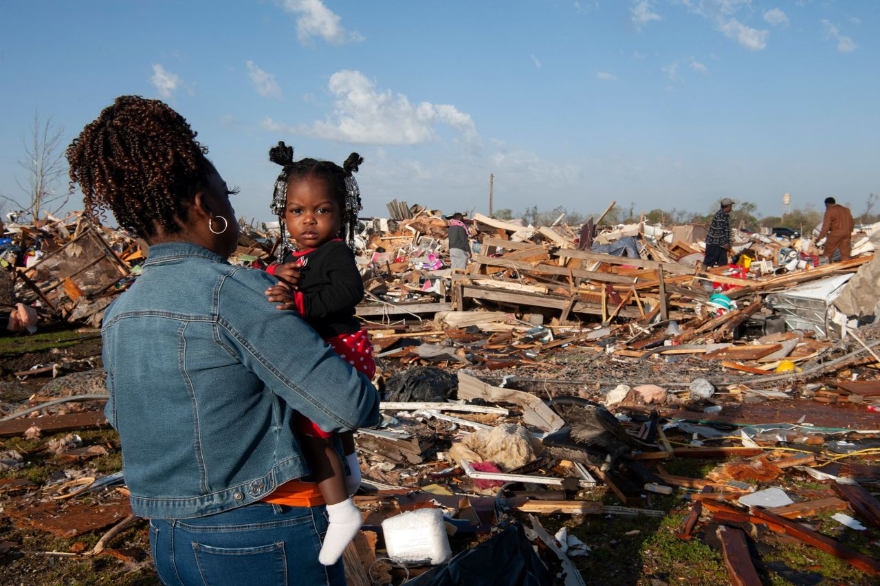 A woman looks at extensive storm damage in Rolling Fork, Mississippi, on Saturday, March 25. <a href="https://www.cnn.com/2023/03/28/us/mississippi-tornado-mother-child/index.html" target="_blank">An outbreak of storms and tornadoes </a>left a trail of destruction that killed at least 21 people in Mississippi alone.