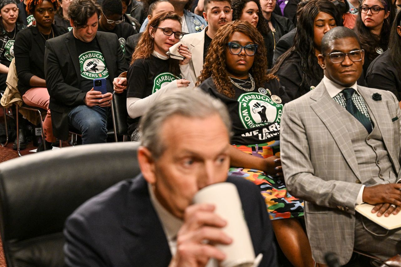 A woman in a Starbucks Workers Union shirt becomes emotional as Howard Schultz, the former Starbucks CEO, prepares to testify before a US Senate committee on Wednesday, March 29. US Sen. Bernie Sanders was among those <a href="https://www.cnn.com/2023/03/29/business/howard-schultz-testimony-starbucks/index.html" target="_blank">who pressed Schultz on the coffee company's labor practices</a>.