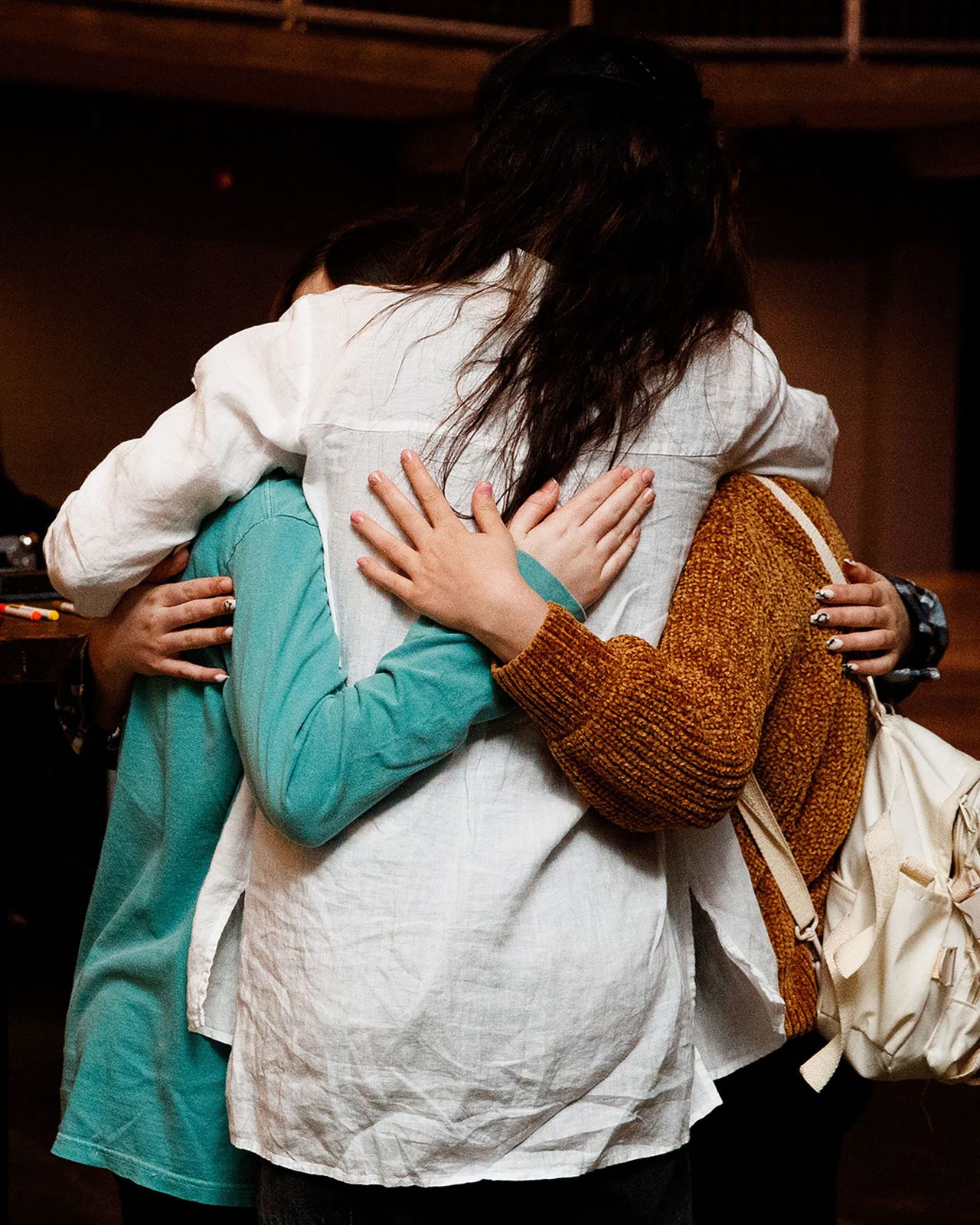 A woman hugs two girls during a vigil for the <a href="https://www.cnn.com/2023/03/28/us/victims-covenant-school-shooting-nashville/index.html" target="_blank">school shooting victims</a> in Nashville on Monday, March 27.