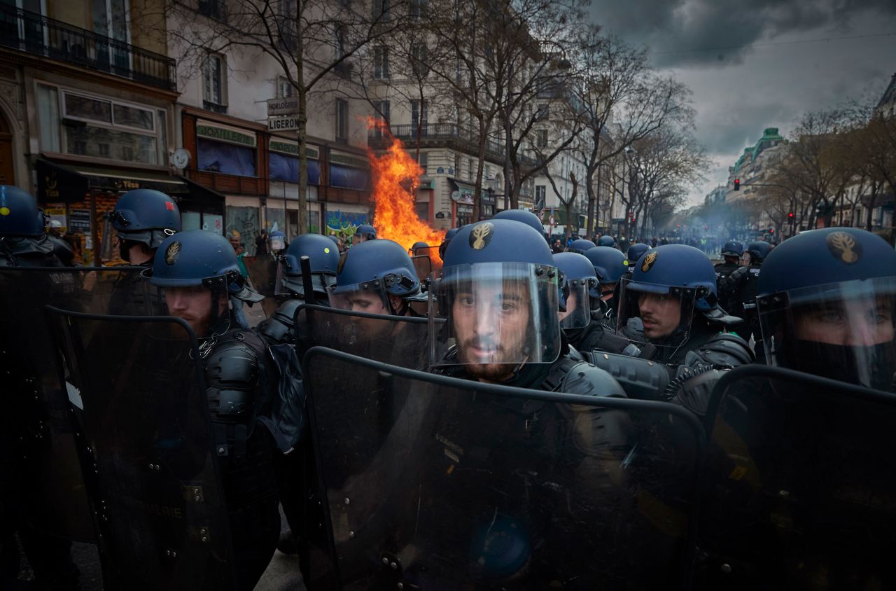 Riot police face protesters during clashes in Paris on Thursday, March 23. Workers in France <a href="https://www.cnn.com/2023/03/23/business/france-national-strike-pension-reform/index.html" target="_blank">staged a national strike that day</a>, protesting a retirement-age increase that was pushed through parliament without a vote.