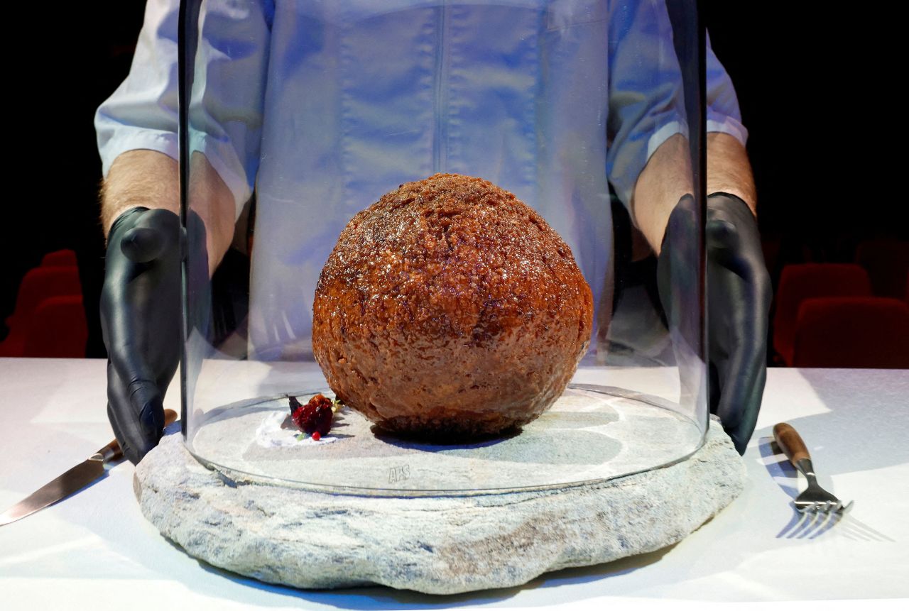 A giant meatball, made with a tiny amount of woolly mammoth DNA, is presented at a science museum in Amsterdam, Netherlands, on Tuesday, March 28. <a href="https://www.cnn.com/2023/03/28/world/mammoth-meatballs-cultured-meat-climate-scn/index.html" target="_blank">The publicity stunt </a>was the work of Vow, an Australian cultured meat startup.