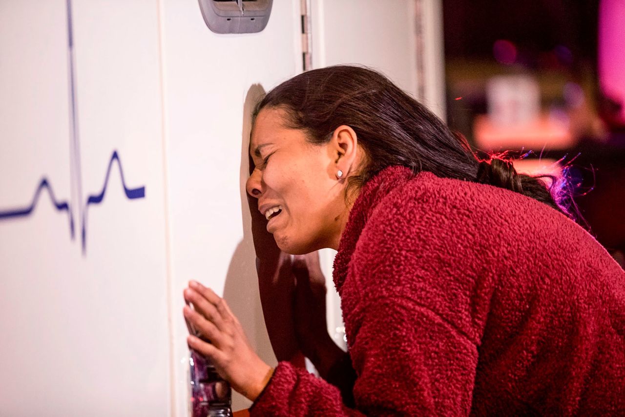 A crying migrant leans on an ambulance as a person she knows is attended to by medics in Ciudad Juarez, Mexico, on Monday, March 27. At least 38 people died <a href="https://www.cnn.com/2023/03/28/americas/mexico-migrants-fire-intl/index.html" target="_blank">when a fire broke out </a>at a government-run migrant detention center in Ciudad Juarez.