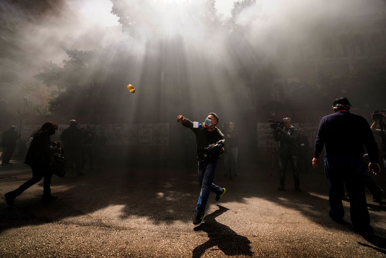 A protester throws a bottle at the Lebanese Central Bank building in Beirut on Friday, March 24. The country has been in a<a href="https://www.cnn.com/2022/09/22/asia/lebanon-banks-shut-holdups-intl/index.html" target="_blank"> financial crisis</a> since 2019.