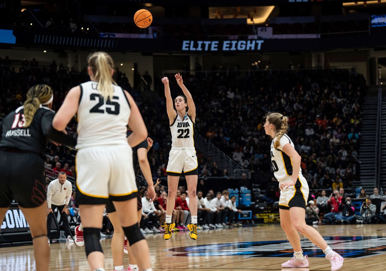 Iowa's <a href="https://www.cnn.com/2023/03/27/sport/caitlin-clark-march-madness-final-four-spt-intl/index.html" target="_blank">Caitlin Clark</a> shoots a 3-pointer during the NCAA Tournament game against Louisville on Sunday, March 26. Clark became the first player in NCAA Tournament history — men's or women's — to record a 40-point triple-double. She finished with 41 points, 12 assists and 10 rebounds as Iowa won 97-83 to book a spot in the Final Four.