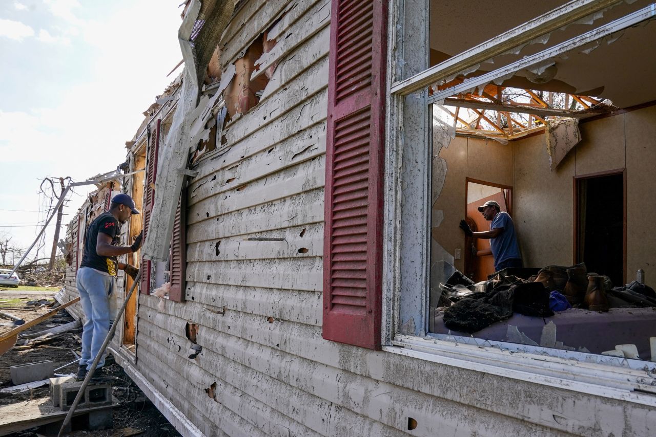 Eric Reed, left, helps his father, A.C. Warfield, salvage what he can on Sunday, March 26, after a <a href="https://www.cnn.com/2023/03/28/us/mississippi-tornado-mother-child/index.html" target="_blank">disastrous tornado</a> tore through Rolling Fork, Mississippi.