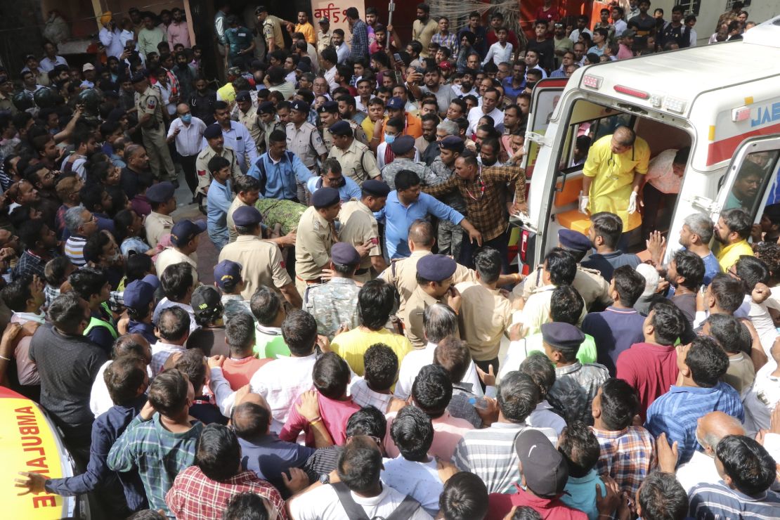 A victim is carried to an ambulance in Indore, India, on March 30.