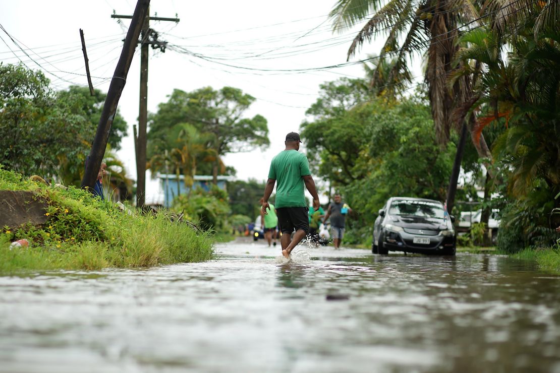 Residents wade through flooded streets in Fiji's capital city of Suva in December 2020 as Cylone Yasa approached.
