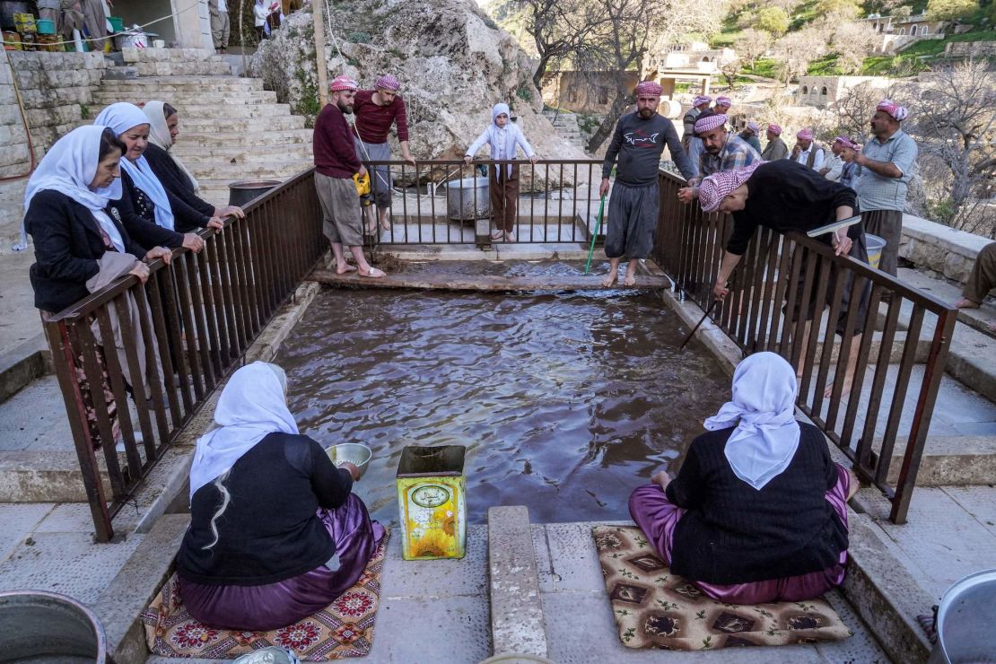 Yazidi devotees press olives during an annual religious tradition at the Lalish Temple in a valley near the Kurdish city of Dohuk in Iraq's autonomous Kurdistan region on Thursday.  