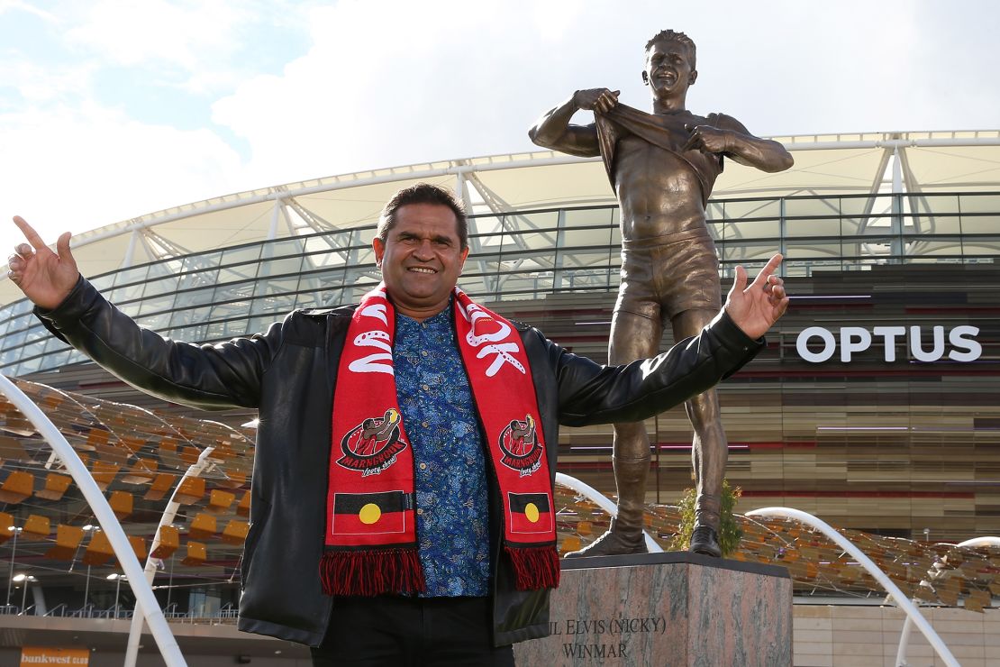 Nicky Winmar poses with his statue in Perth, Australia, in 2019. 