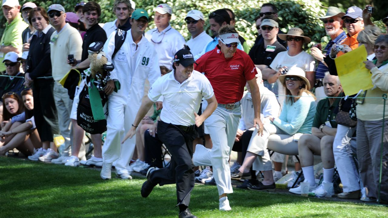 McIlroy (L) races England's Ian Poulter (R) during the Par 3 Contest prior to the 2011 Masters.