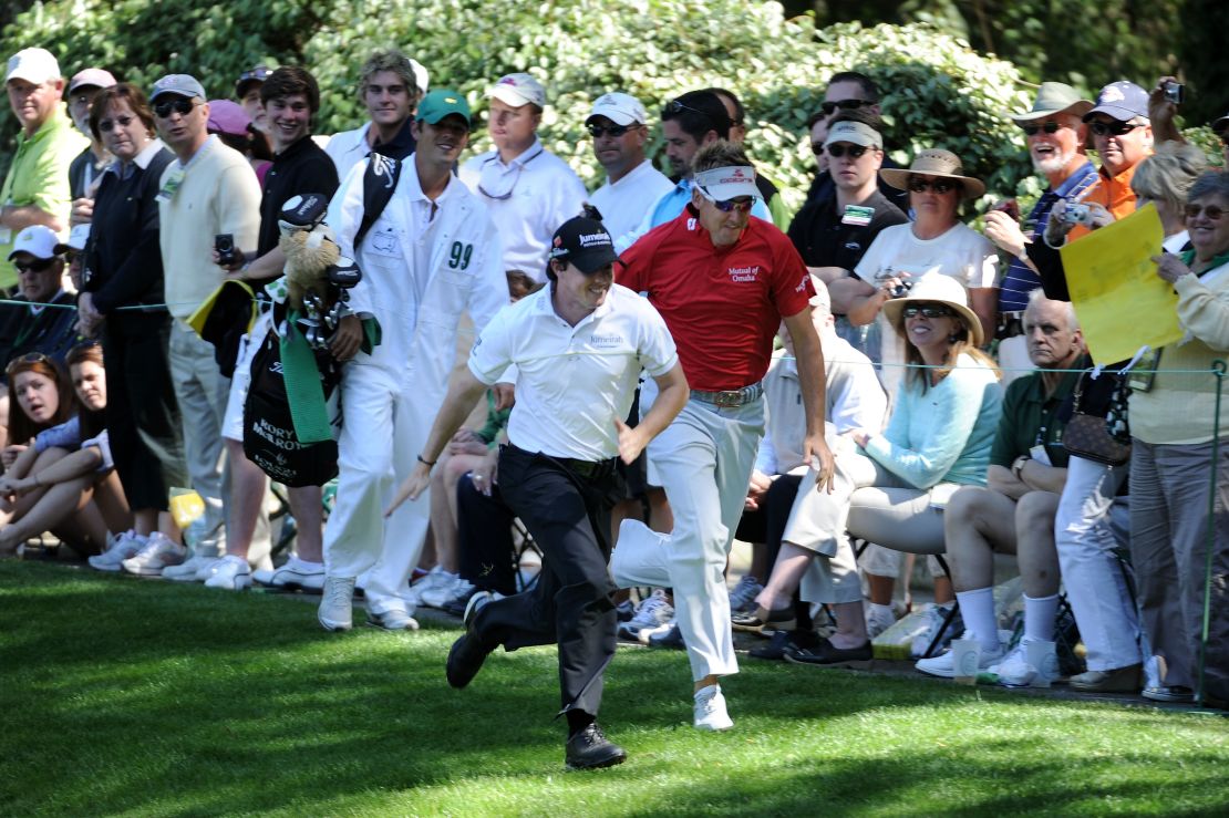 McIlroy (L) races England's Ian Poulter (R) during the Par 3 Contest prior to the 2011 Masters.