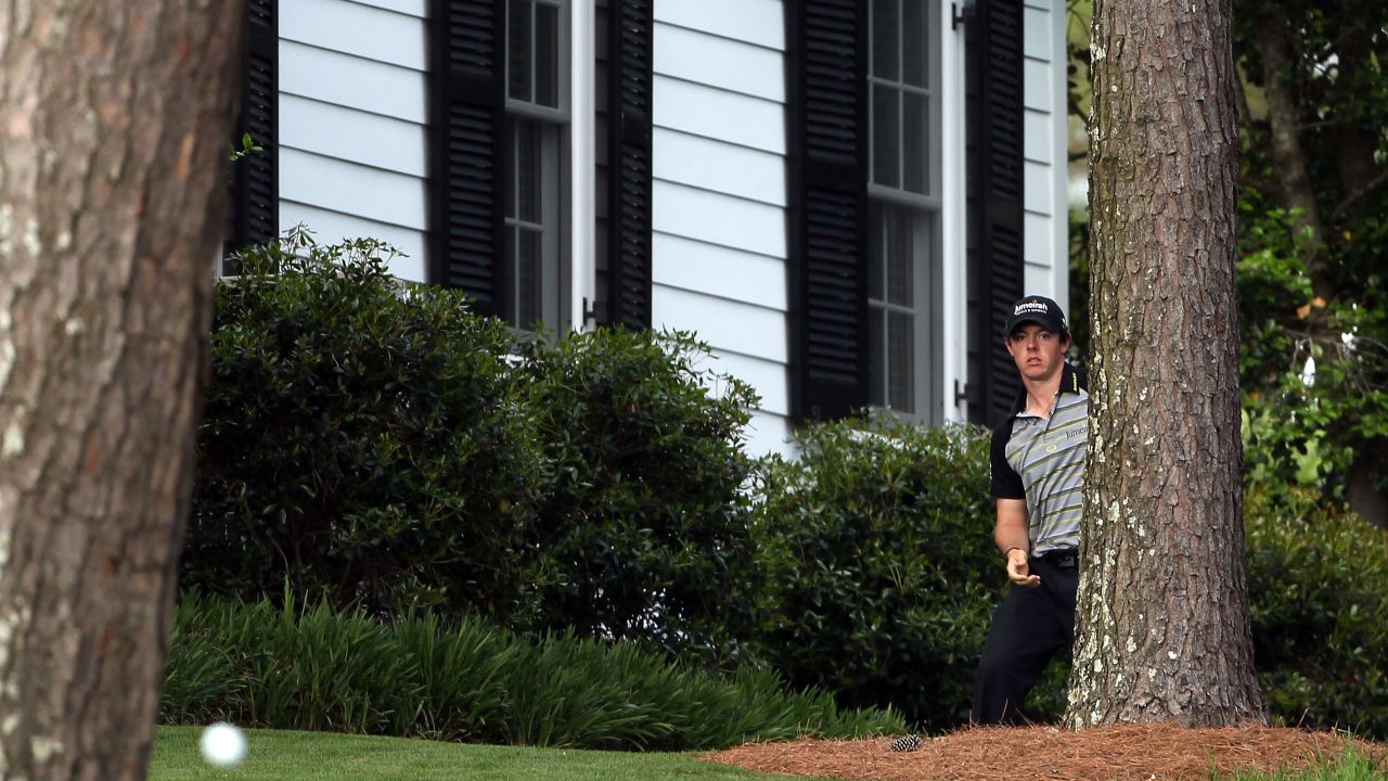 McIlroy watches his shot after his initial drive from the 10th tee put him close to Augusta's cabins.
